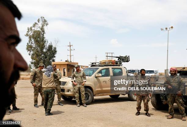 Members of the Syrian Democratic Forces and US soldiers gather at the al-Tanak oil field as they prepare to relaunch a military campaign against the...