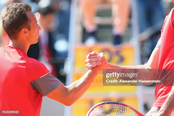 Philipp Kohlschreiber of Germany shake hand with Ivo Karlovic of Croatia after their first round match on day 4 of the BMW Open by FWU at MTTC...