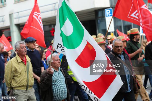 Man with a flag of the Italian governing party Partito Democratico . Several thousands followed the invitation of the trade unions such as IG Metall,...