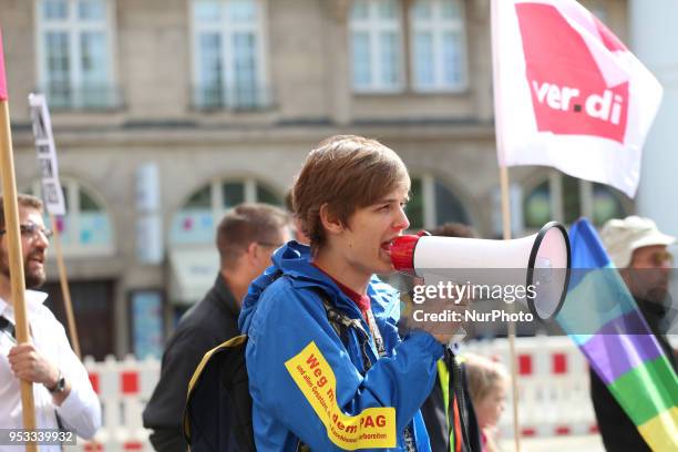 An activist with a bullhorn. Several thousands followed the invitation of the trade unions such as IG Metall, Verdi, GEW and others to protest at the...