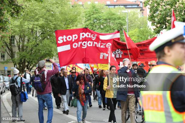 Protestors carry banners against the new Poliziaufgabengesetz of the CSU party as a policeman looks at them. Several thousands followed the...