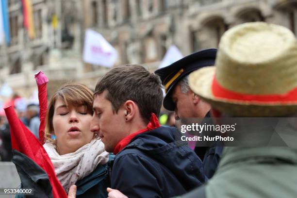 An angry policeman aggresively pushes some activists away. Several thousands followed the invitation of the trade unions such as IG Metall, Verdi,...