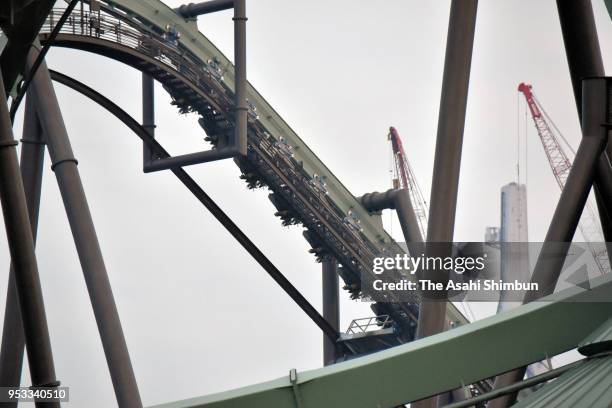 Passengers of rollercoaster Flying Dinosaur are hung in the air after the emergency stop at the Universal Studio Japan on May 1, 2018 in Osaka, Japan.