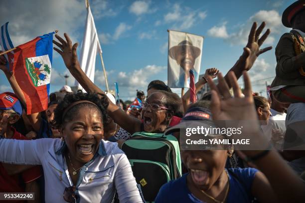 Cubans cheer during the May Day rally at Revolution Square in Havana on May 1, 2018.