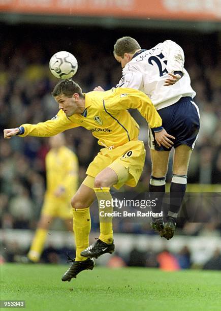 Eirik Bakke of Leeds United heads the ball under the challenge of Stephen Clemence of Tottenham Hotspur during the FA Carling Premiership match at...