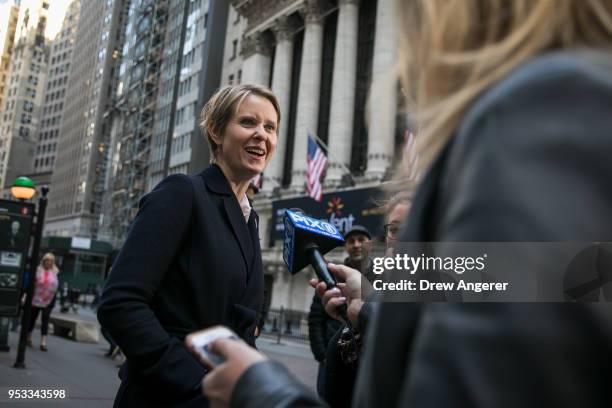 New York gubernatorial candidate Cynthia Nixon speaks with reporters following a rally against financial institutions' support of private prisons and...