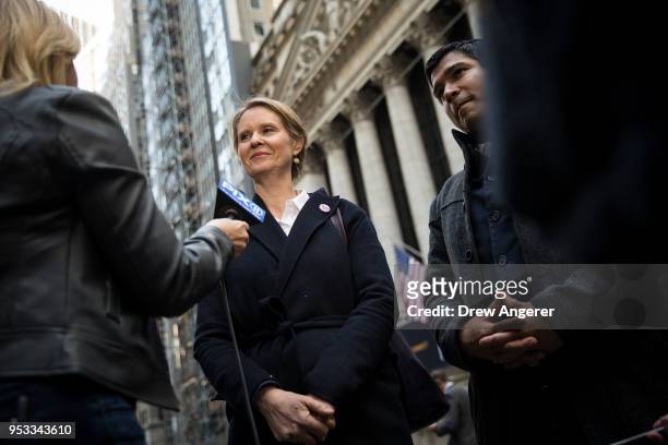 New York gubernatorial candidate Cynthia Nixon speaks with reporters following a rally against financial institutions' support of private prisons and...