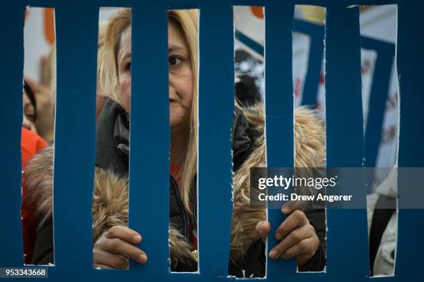 Activists rally against financial institutions' support of private prisons and immigrant detention centers, as part of a May Day protest near Wall...