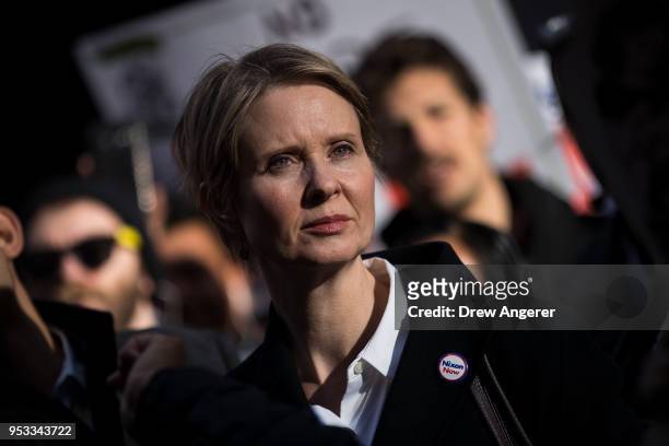New York gubernatorial candidate Cynthia Nixon stands with activists as they rally against financial institutions' support of private prisons and...