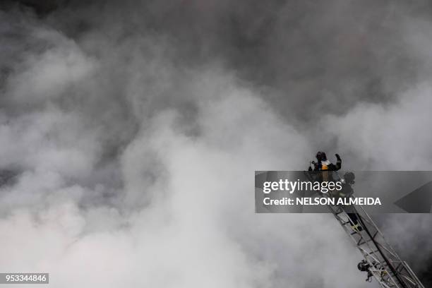 Firefighters work to extinguish the fire in a building that collapsed after catching fire in Sao Paulo, Brazil, on May 1, 2018. - A 24-storey...