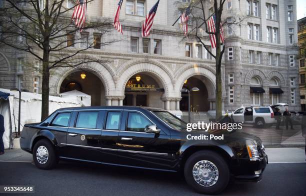 The presidential limousine, aka The Beast, is parked in front of the Trump hotel as US President Donald Trump attends dinner with supporters on April...