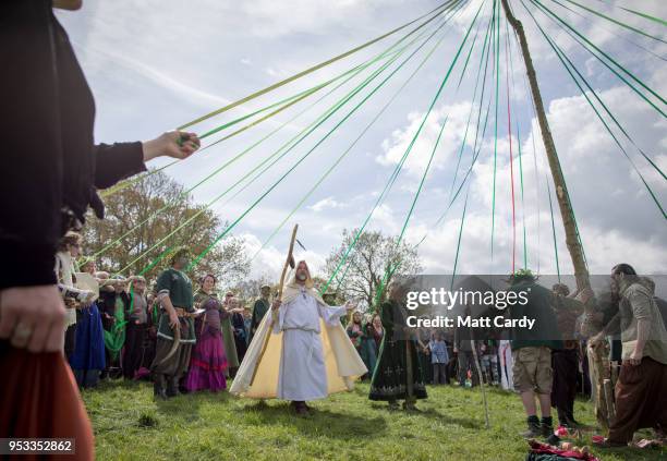 People dance around this year's Maypole at a ceremony at Bushy Combe below Glastonbury Tor as part of the town's Beltane May Day celebrations on May...