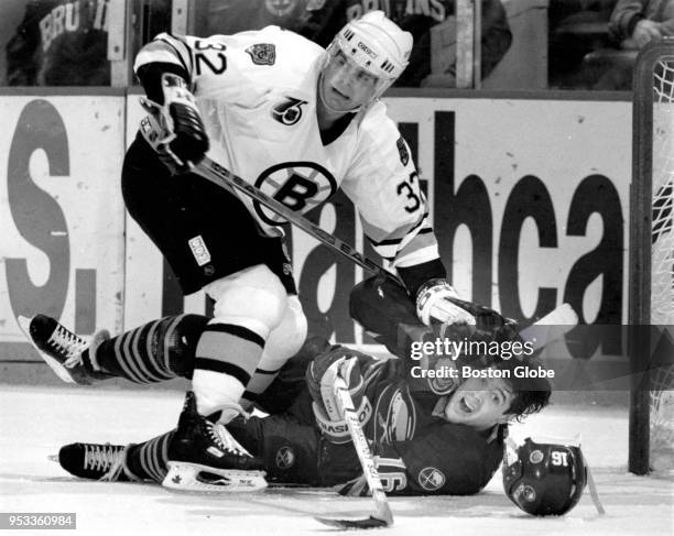 Boston Bruins' Don Sweeney stands over Buffalo Sabres' Pat LaFontaine during Game Seven of the first round of the 1992 Stanley Cup playoffs at the...