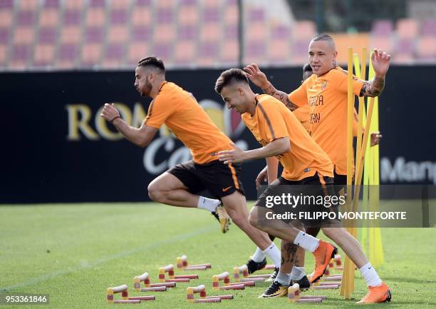 Roma's Belgian midfielder Radja Nainggolan , Egyptian forward Stephan El Shaarawy and Greek defender Kostas Manolas attend a training session at Roma...