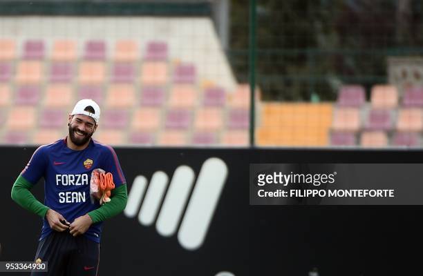 Roma's Brazilian goalkeeper Alisson Ramses Becker attends a training session at Roma training ground in Trigoria on May 1 a day before their...