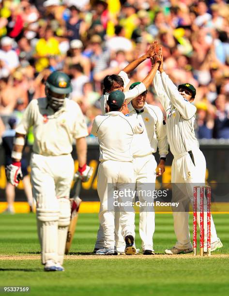Pakistan players celebrate the wicket of Simon Katich of Australia during day one of the First Test match between Australia and Pakistan at Melbourne...