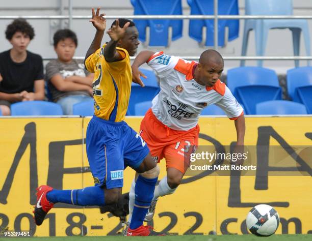 Henrique of Roar contests the ball with Adama Traore of United during the round 21 A-League match between Gold Coast United and Brisbane Roar at...