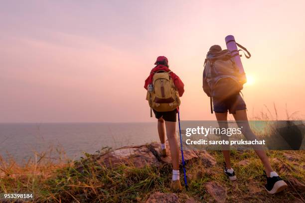 two young asian female hipster hiking on mountain holiday, wild adventure. background for travel concept - people climbing walking mountain group stockfoto's en -beelden