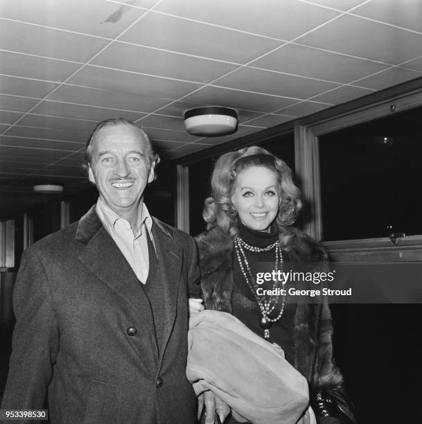 English actor and novelist David Niven with his wife, former fashion model Hjordis Genberg at Heathrow Airport, London, UK, 22nd November 1971.