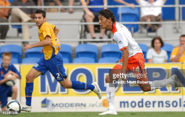 Adam Sarota of Roar makes a break past Steve Pantelidis of United during the round 21 A-League match between Gold Coast United and Brisbane Roar at...