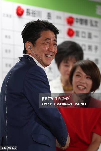 Japanese Prime Minister and ruling Liberal Democratic Party president Shinzo Abe shakes hands with his party's candidate Eriko Imai as she won the...