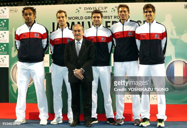 French team members and French Tennis Federation president Jean Gachassin pose for photo at a drawing event of the Davis Cup World Group first round...