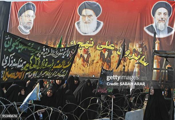 Huge banner hangs with the images of the late Abdul Aziz al-Hakim , head of SCIRI and his assassinated brother his assassinated brother Mohammed...