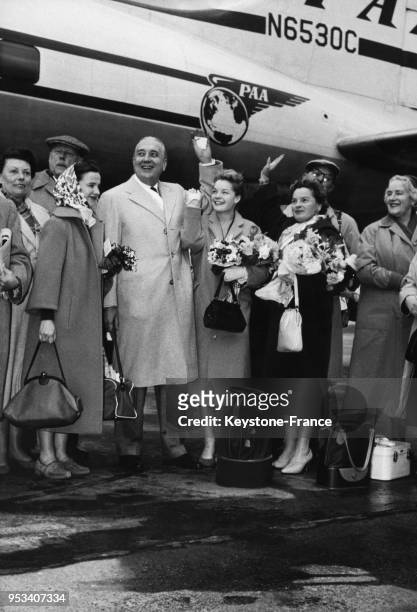 In Front of the aircraft, the actress Romy Schneider and her parents greet the crowd in February 12, 1957.