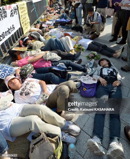 Women from Fukushima prefecture and their suppoters in the die-in protest in front of prime minister's official residence in Tokyo as they against...