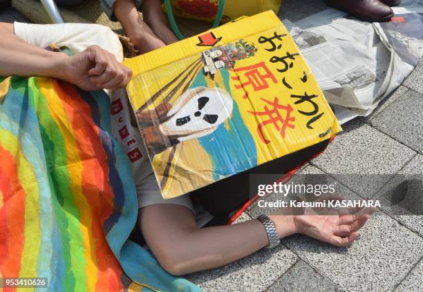 Women from Fukushima prefecture and their suppoters in the die-in protest in front of prime minister's official residence in Tokyo as they against...