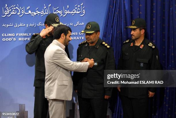 Iranian President Mahmoud Ahmadinejad presents a medal of honour to Iranian revolutionary guards commander Abolqasem Amangah , who was among those...