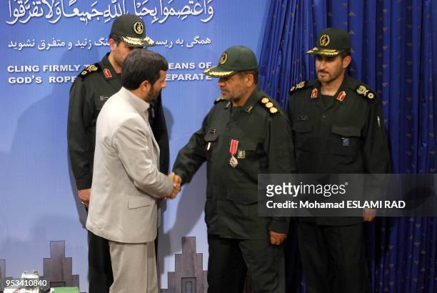 Iranian President Mahmoud Ahmadinejad presents a medal of honour to Iranian revolutionary guards commander Abolqasem Amangah , who was among those...
