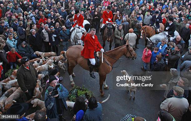 Jonathon Seed, Joint Master and Huntsman with the Avon Vale Hunt, salutes the crowd of supporters as they gather for their traditional Boxing Day...