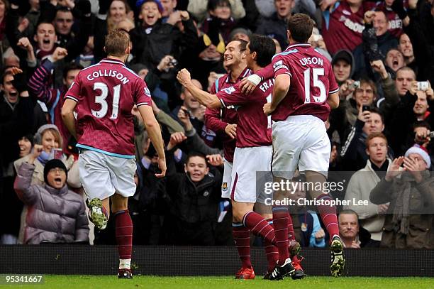 Alessandro Diamanti of West Ham United celebrates with his team mates after he scored a penalty during the Barclays Premier League match between West...