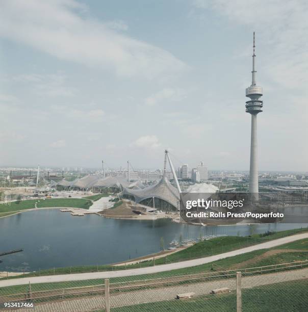 June 1972 of the Olympiaturm or Olympic Tower and the Munich Olympic Park with the Olympic Stadium, Olympic Swim Hall and Olympiahalle all in the...