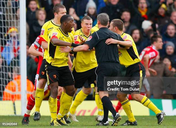 Players of Watford surround referee Andrew D'Urso for not awarding a penalty during the Coca Cola Championship match between Watford and Nottingham...