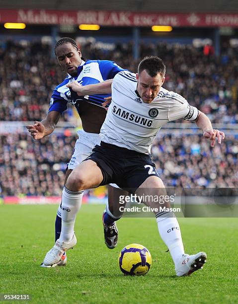 John Terry of Chelsea pulls the shirt of Cameron Jerome of Birmingham City during the Barclays Premier League match between Birmingham City and...