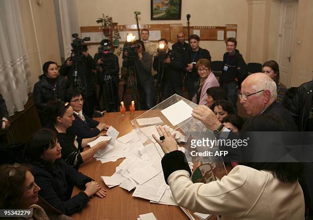 Abkhazian election officials empty the ballot-box to begin the vote count at a polling station in Sukhumi on December 12, 2009. The rebel region of...