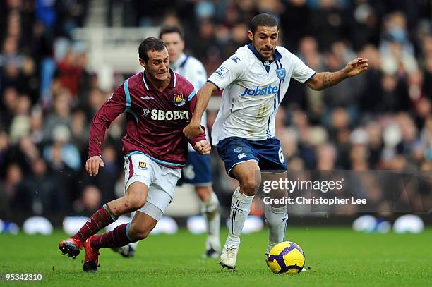 Hayden Mullins of Portsmouth battles for the ball with Alessandro Diamanti of West Ham United during the Barclays Premier League match between West...