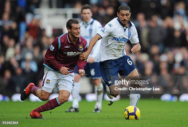 Hayden Mullins of Portsmouth battles for the ball with Alessandro Diamanti of West Ham United during the Barclays Premier League match between West...
