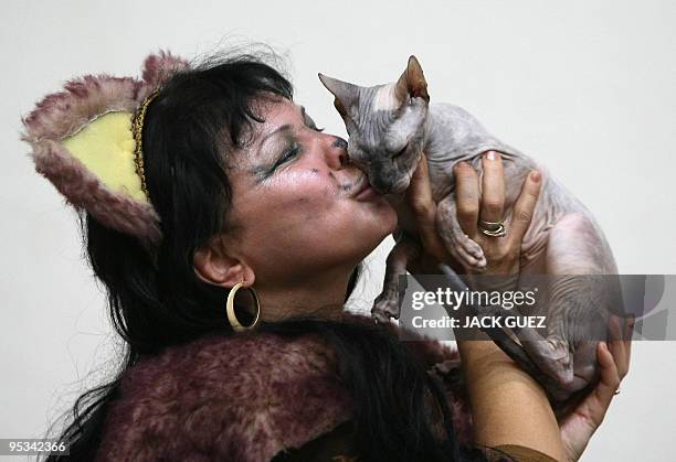 Woman kisses her Don Sphynx during an international cat show in Moshav Beit Hefer near the coastal city of Netanya, north of Israel, on December 26,...