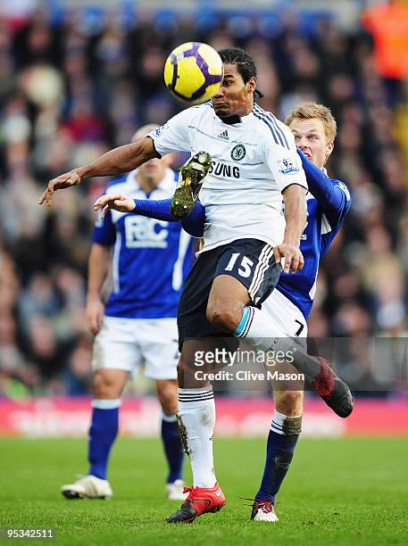 Florent Malouda of Chelsea is challenged by Sebastian Larsson of Birmingham City during the Barclays Premier League match between Birmingham City and...