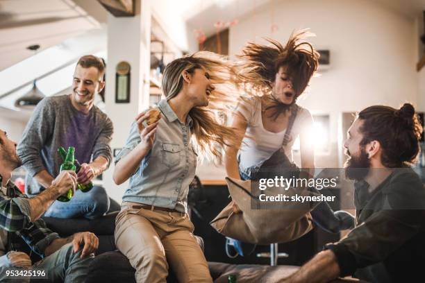 young happy people having fun during a home party in the living room. - social action party stock pictures, royalty-free photos & images