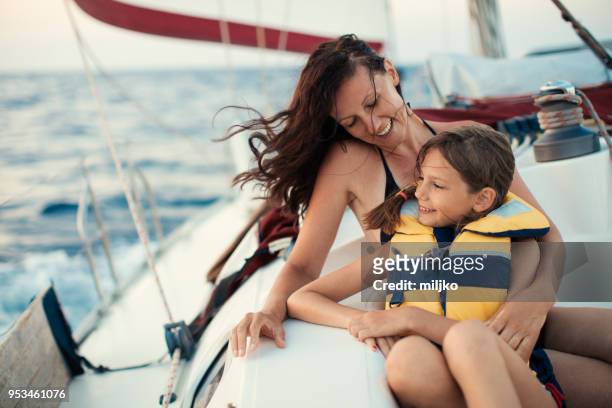 mother and daughter enjoying on yacht - sailing greece stock pictures, royalty-free photos & images