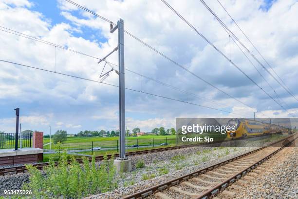 intercity train of the dutch railways, ns, driving past at kampen zuid station - kampen overijssel stock pictures, royalty-free photos & images