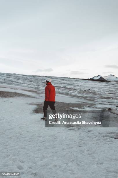 man in helmet exploring vatnajokull glacier - breidamerkurjokull glacier stock pictures, royalty-free photos & images