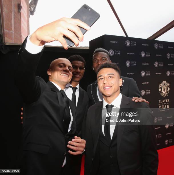 Former player Wes Brown photographs Marcus Rashford, Paul Pogba and Jesse Lingard of Manchester United arriving at Old Trafford ahead of the club's...