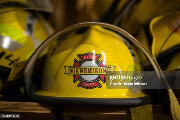 Stack of used firefighting helmets sits in the public works building in Mishkeegogamang First Nation. The helmets once belonged to the Wikwemikong...