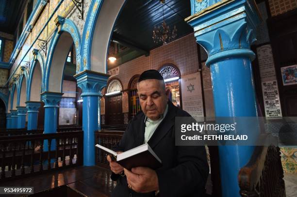 Peres Trabelsi, the president of the Ghriba synagogue, reads the Torah on May 1, 2018 in the Tunisian resort island of Djerba, one day before of the...
