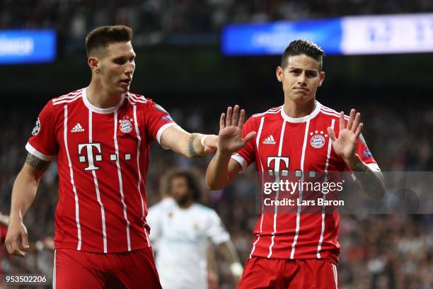 James Rodriguez of Bayern Muenchen celebrates as he scores his sides second goal with Niklas Suele of Bayern Muenchen during the UEFA Champions...